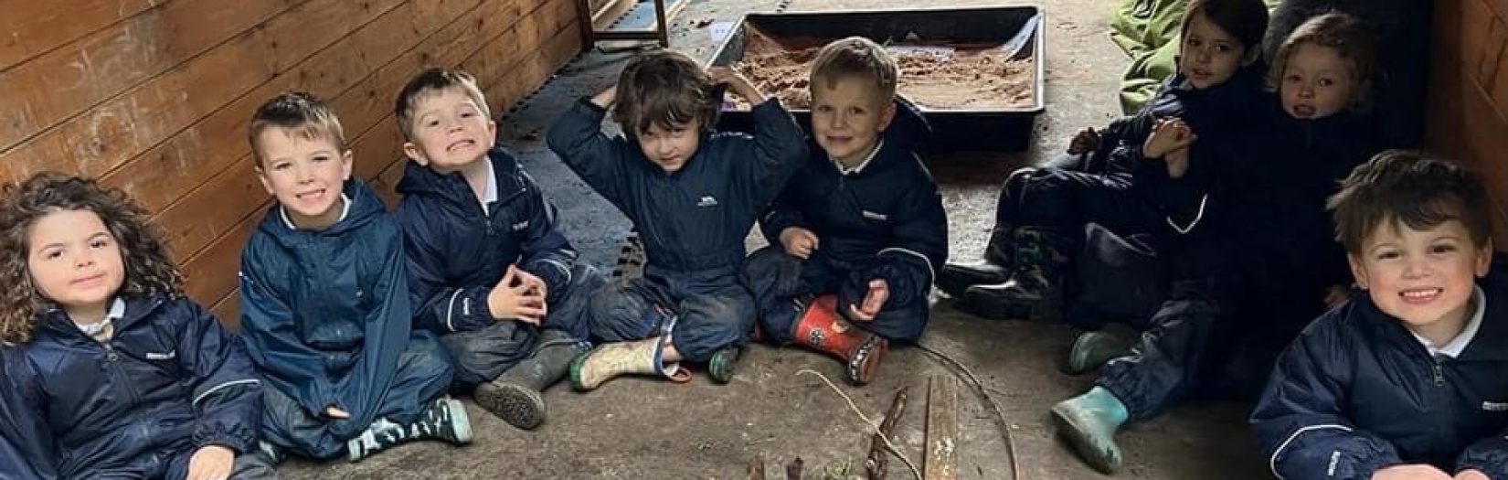 children in woodland shelter